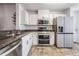 Contemporary kitchen with stainless steel appliances and white cabinets at 2335 E Del Webb Blvd, Sun City Center, FL 33573