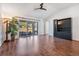 Open living room has wood floors, sliding glass doors and a ceiling fan at 2335 E Del Webb Blvd, Sun City Center, FL 33573