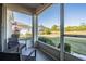 The screened porch offers views of a fenced-in backyard with lush landscaping and screened pool at 2335 E Del Webb Blvd, Sun City Center, FL 33573