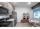 Dining area with stainless steel appliances and a storage unit with decorations at 25933 Bimini Sands Ct, Englewood, FL 34223