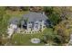 Stunning aerial view of a beautiful two-story home, showcasing its manicured lawn, fountain, and lush surroundings at 27625 Lincoln Pl, Wesley Chapel, FL 33544