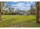 Expansive backyard features a fire pit area and screened-in pool, perfect for outdoor enjoyment at 27625 Lincoln Pl, Wesley Chapel, FL 33544