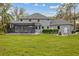 Expansive backyard features a fire pit area and screened-in pool, perfect for outdoor enjoyment at 27625 Lincoln Pl, Wesley Chapel, FL 33544