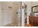 Well-lit bathroom with a glass-enclosed shower and a wooden vanity with granite countertops at 27625 Lincoln Pl, Wesley Chapel, FL 33544