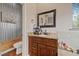 Charming bathroom features a granite countertop and unique metal and wood wall accents at 27625 Lincoln Pl, Wesley Chapel, FL 33544
