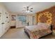 Cozy bedroom with a ceiling fan, double closets, a tapestry wall hanging, and a window with blinds at 27625 Lincoln Pl, Wesley Chapel, FL 33544