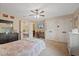 Comfortable bedroom with dual closets, ceiling fan, and a desk area in an alcove connected to the main room at 27625 Lincoln Pl, Wesley Chapel, FL 33544