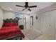 Bright bedroom featuring neutral walls, ceiling fan, a tv on the wall, and dual closets for ample storage at 27625 Lincoln Pl, Wesley Chapel, FL 33544