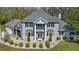 Stately two-story home boasts bay windows, a second story porch and mature landscaping at 27625 Lincoln Pl, Wesley Chapel, FL 33544