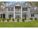 Charming two-story home featuring a balcony, bay windows, manicured lawn, and a beautifully landscaped front yard at 27625 Lincoln Pl, Wesley Chapel, FL 33544