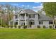 Charming two-story home with a gray exterior, balcony, meticulously landscaped front yard, and welcoming curb appeal at 27625 Lincoln Pl, Wesley Chapel, FL 33544