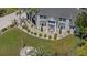 Charming two-story home showcasing a beautifully landscaped front yard, manicured bushes, and attractive architectural details at 27625 Lincoln Pl, Wesley Chapel, FL 33544