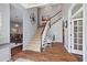Grand foyer with wood flooring, staircase, chandelier, and decorative accents create a welcoming ambiance at 27625 Lincoln Pl, Wesley Chapel, FL 33544