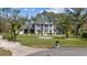Beautiful two-story home with a well-manicured lawn, decorative fountain, and mature trees, showcasing curb appeal at 27625 Lincoln Pl, Wesley Chapel, FL 33544