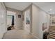 Hallway shows entrances to a bathroom and bedroom, with wall art and a staircase leading to the lower level at 27625 Lincoln Pl, Wesley Chapel, FL 33544