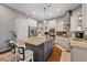 Island kitchen with stainless appliances, a tile backsplash, and granite countertops at 27625 Lincoln Pl, Wesley Chapel, FL 33544