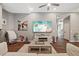 Open living room featuring high ceilings, wood floors, and a wall-mounted television at 27625 Lincoln Pl, Wesley Chapel, FL 33544
