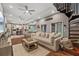 Spacious living room showcasing an open floor plan, hardwood floors, and large windows at 27625 Lincoln Pl, Wesley Chapel, FL 33544