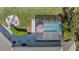 Aerial view of an inviting screened pool area with an adjacent fire pit and outdoor seating for entertainment at 27625 Lincoln Pl, Wesley Chapel, FL 33544