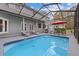 The inviting pool is surrounded by a screened enclosure, lounge chairs, and lush greenery at 27625 Lincoln Pl, Wesley Chapel, FL 33544