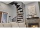 View of spiral staircase adjacent to fireplace and living area at 27625 Lincoln Pl, Wesley Chapel, FL 33544