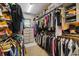 Walk-in closet featuring well-organized shelving and plenty of space for clothes, shoes, and accessories at 27625 Lincoln Pl, Wesley Chapel, FL 33544