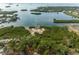 Breathtaking aerial view of a tranquil waterfront setting with a dock and lush green landscape at 314 Ontario Ave, Crystal Beach, FL 34681