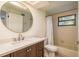 Bathroom boasts a stylish round mirror, vanity with great storage, and shower-tub combo at 314 Ontario Ave, Crystal Beach, FL 34681