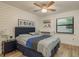 Bedroom features wood-look flooring, a ceiling fan, shiplap wall, and a built-in desk at 314 Ontario Ave, Crystal Beach, FL 34681