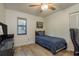 This is a bedroom featuring a ceiling fan, wood-look floors, and a small window at 314 Ontario Ave, Crystal Beach, FL 34681