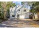 Charming two-story home featuring a light blue door and a spacious driveway at 314 Ontario Ave, Crystal Beach, FL 34681