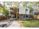 Charming home with a screened porch and wooden staircase, set amongst mature trees at 314 Ontario Ave, Crystal Beach, FL 34681