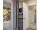 Laundry room featuring a stacked washer and dryer, with access to the backyard at 314 Ontario Ave, Crystal Beach, FL 34681