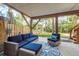 Outdoor patio area with comfortable seating, a wooden fence, and access to the lawn at 314 Ontario Ave, Crystal Beach, FL 34681