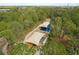 Aerial view of covered playground area surrounded by green trees, offering fun activities for  at 314 Ontario Ave, Crystal Beach, FL 34681