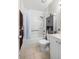 Bathroom with white tub and shower, gray vanity, tile floor, and grab bar for accessibility at 4152 56Th N Way # 614, Kenneth City, FL 33709