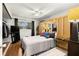 Well-lit bedroom features wood floors and updated fixtures at 4152 56Th N Way # 614, Kenneth City, FL 33709