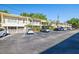 Full exterior of property showcases assigned parking, awnings over front sitting area, and second story units at 4152 56Th N Way # 614, Kenneth City, FL 33709