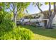 Exterior of condo building with mature trees and landscaping at 4152 56Th N Way # 614, Kenneth City, FL 33709
