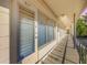 Hallway view of the exterior featuring a covered walkway and adjacent parking at 4152 56Th N Way # 614, Kenneth City, FL 33709