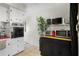 Kitchen with white cabinets and stainless appliances, next to built-in storage and cabinets at 4152 56Th N Way # 614, Kenneth City, FL 33709