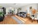 Living room with hardwood floors, ceiling fan, plants, and a comfortable black leather sofa at 4152 56Th N Way # 614, Kenneth City, FL 33709