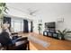 Living room with wood floors, a ceiling fan, and large windows with lots of light at 4152 56Th N Way # 614, Kenneth City, FL 33709