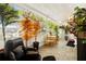 Enclosed patio featuring tile floor, seating, ceiling fan, and lots of plants at 4152 56Th N Way # 614, Kenneth City, FL 33709