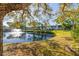 Scenic pond view with a fountain, surrounded by lush landscaping, enhancing community's tranquil setting at 4152 56Th N Way # 614, Kenneth City, FL 33709