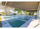 Community shuffleboard court providing an outdoor recreational activity with shaded seating for onlookers at 4152 56Th N Way # 614, Kenneth City, FL 33709
