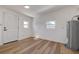 Bonus room featuring wood floors, white walls, and natural light at 4712 W Iowa Ave, Tampa, FL 33616