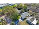 An aerial shot showcases a well-maintained home with a modern roof and green lawn in a cozy neighborhood at 509 13Th Nw Ave, Largo, FL 33770