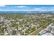 Wide aerial view of a neighborhood with lush greenery and a cityscape in the distance at 509 13Th Nw Ave, Largo, FL 33770