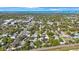 Expansive aerial view featuring a residential neighborhood with lush greenery and distant water views at 509 13Th Nw Ave, Largo, FL 33770